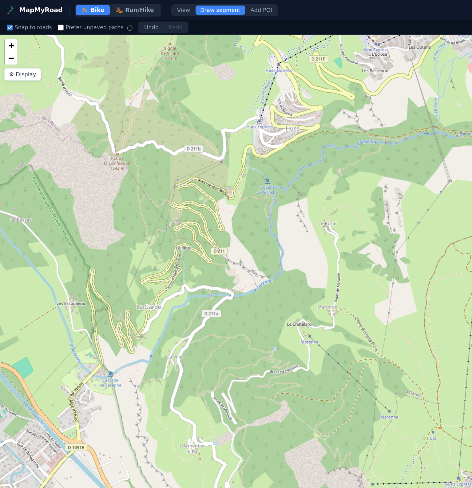 MapMyRoad's Draw segment mode on a mountain road near Alpe d'Huez, with Snap to roads and Prefer unpaved paths options